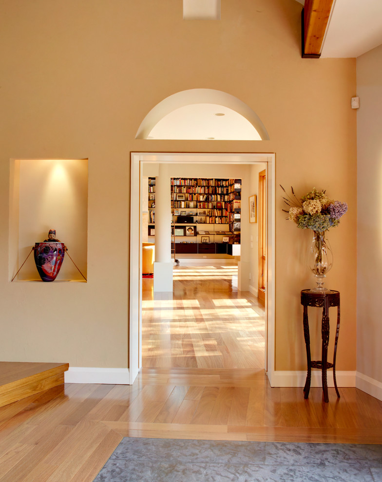 Design ideas for a large traditional foyer in New York with yellow walls, medium hardwood floors, a double front door and a medium wood front door.
