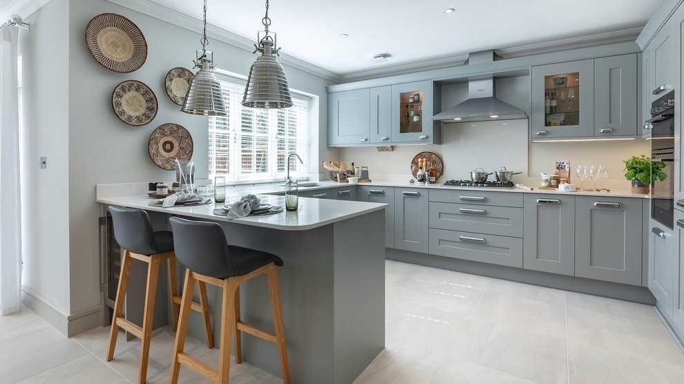 Inspiration for a country u-shaped kitchen in Berkshire with an undermount sink, shaker cabinets, grey cabinets, stainless steel appliances, a peninsula, grey floor and white benchtop.