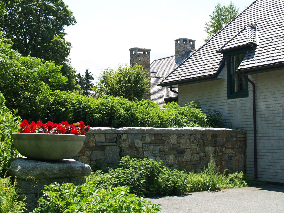 Design ideas for a mid-sized rustic partial sun backyard retaining wall landscape.