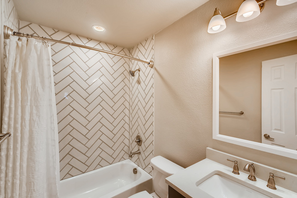 Inspiration for a mid-sized contemporary 3/4 bathroom in Denver with recessed-panel cabinets, grey cabinets, an alcove tub, a shower/bathtub combo, white tile, ceramic tile, brown walls, an undermount sink, quartzite benchtops, white floor, a shower curtain, white benchtops, a single vanity, a built-in vanity and wallpaper.
