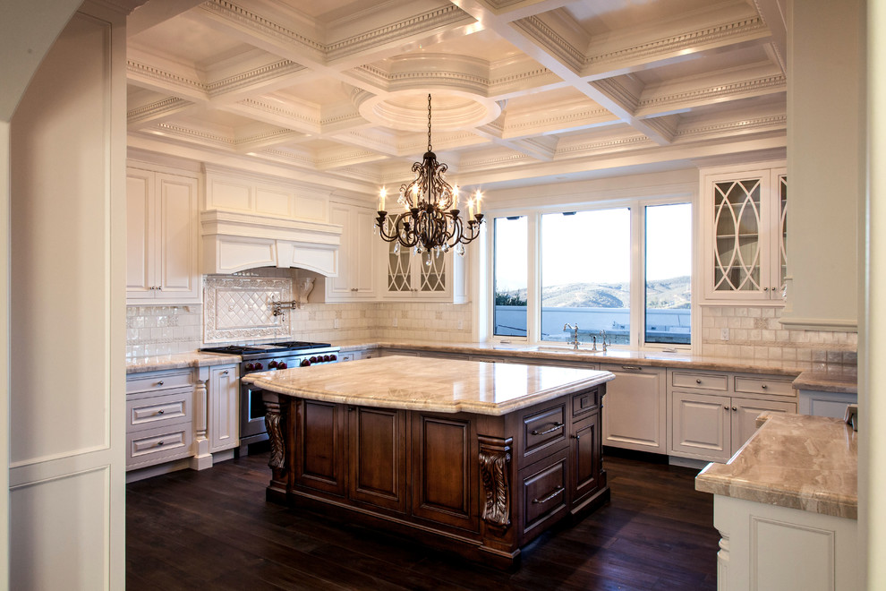 Inspiration for a large traditional u-shaped separate kitchen in Los Angeles with an undermount sink, beaded inset cabinets, white cabinets, marble benchtops, white splashback, ceramic splashback, panelled appliances, dark hardwood floors and with island.