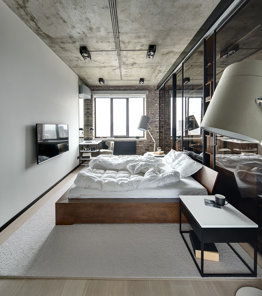 Inspiration for an industrial master bedroom in Moscow with white walls, light hardwood floors and beige floor.