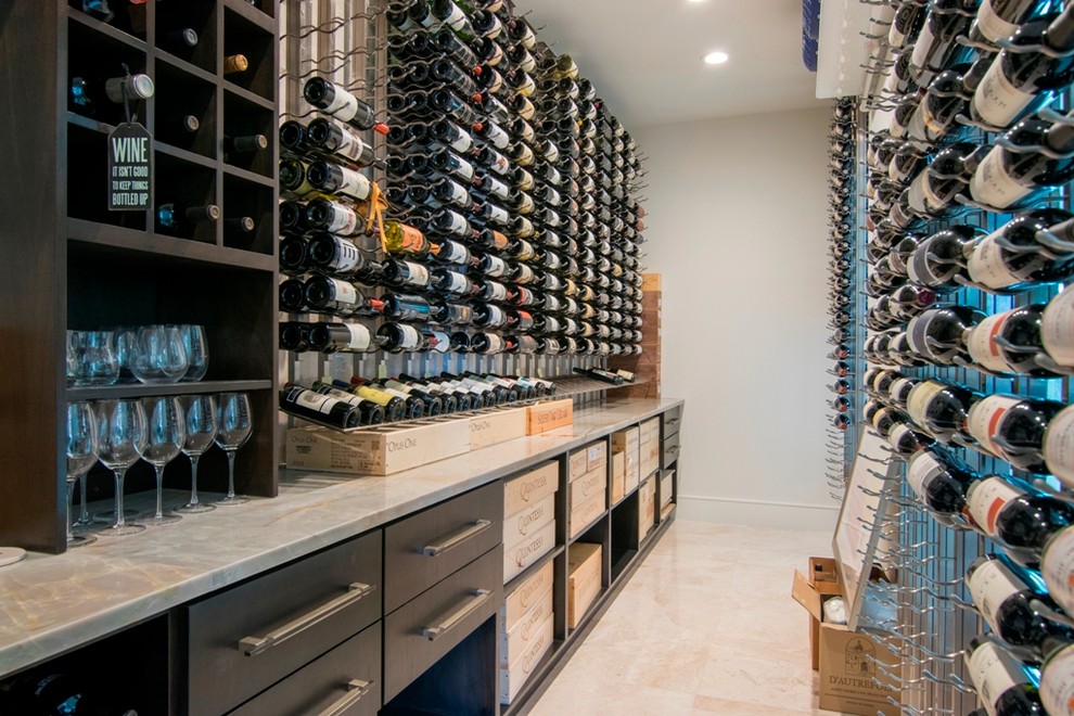 This is an example of a large contemporary wine cellar in Orange County with marble floors, storage racks and beige floor.