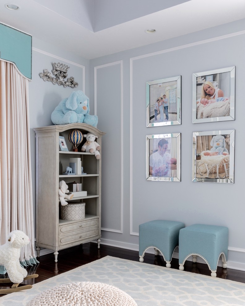 Design ideas for a mid-sized contemporary nursery for boys in New York with blue walls and dark hardwood floors.