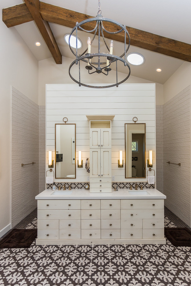 This is an example of a large country master bathroom in Other with beige cabinets, beige tile, porcelain tile, beige walls, porcelain floors, an undermount sink, engineered quartz benchtops, beige benchtops, flat-panel cabinets and multi-coloured floor.