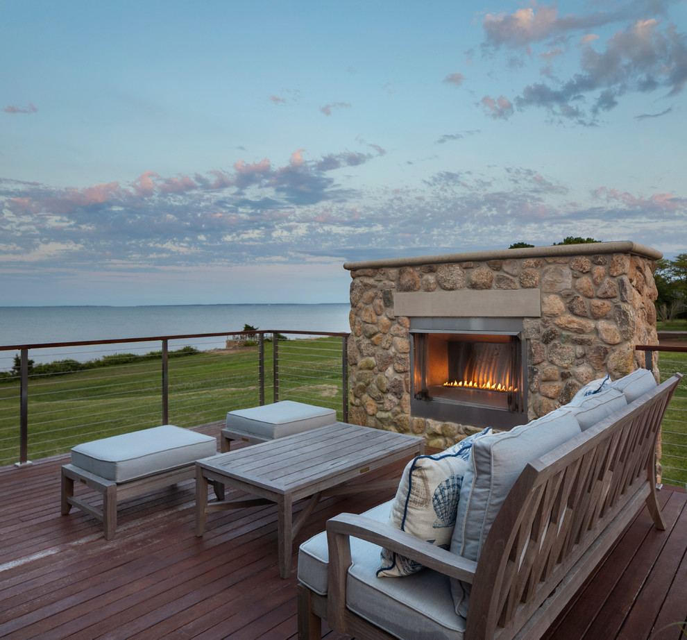 Photo of a mid-sized beach style rooftop deck in Providence with with fireplace and no cover.