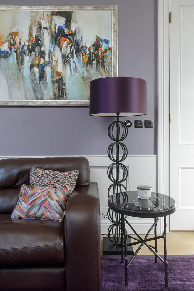 ロンドンにある中くらいなコンテンポラリースタイルのおしゃれなリビング (紫の壁、淡色無垢フローリング、標準型暖炉、石材の暖炉まわり、ベージュの床) の写真