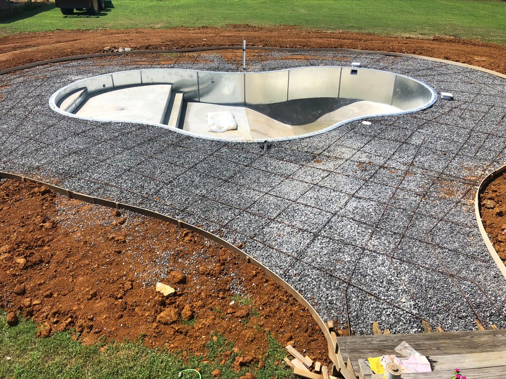 Pool - mid-sized backyard concrete and kidney-shaped lap pool idea