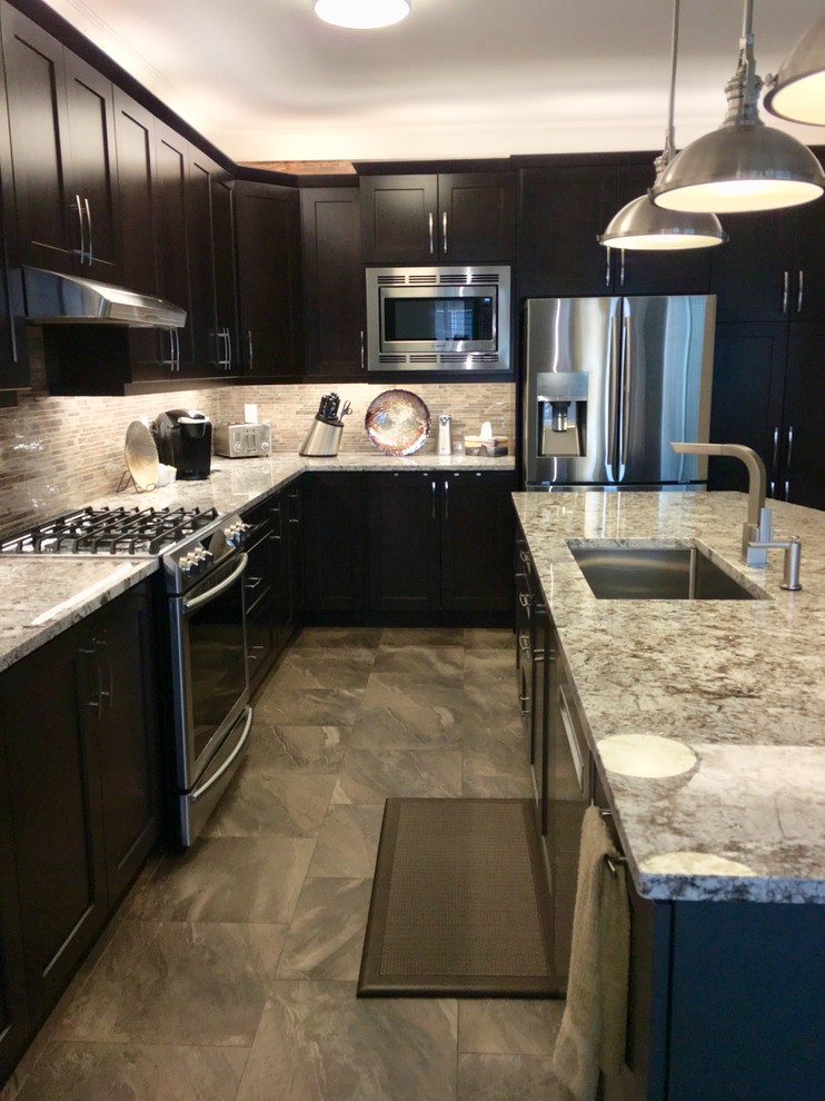 Large contemporary l-shaped separate kitchen in Toronto with an undermount sink, shaker cabinets, dark wood cabinets, granite benchtops, brown splashback, porcelain splashback, stainless steel appliances, porcelain floors, with island, brown floor and white benchtop.