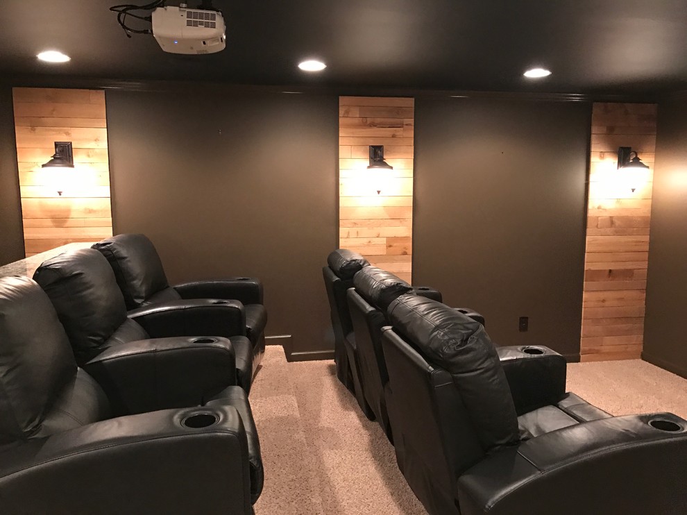 Design ideas for a large industrial enclosed home theatre in Atlanta with black walls, carpet and a projector screen.