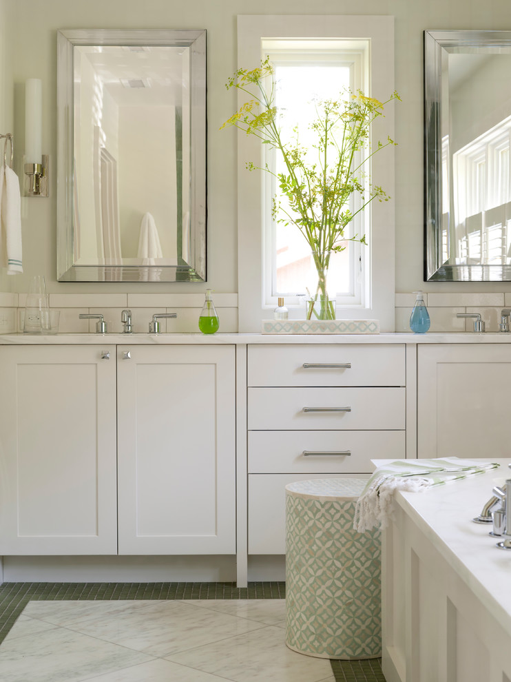Inspiration for a large transitional master bathroom in Boston with shaker cabinets, white cabinets, a drop-in tub, an alcove shower, white tile, ceramic tile, beige walls, marble floors, an undermount sink and marble benchtops.
