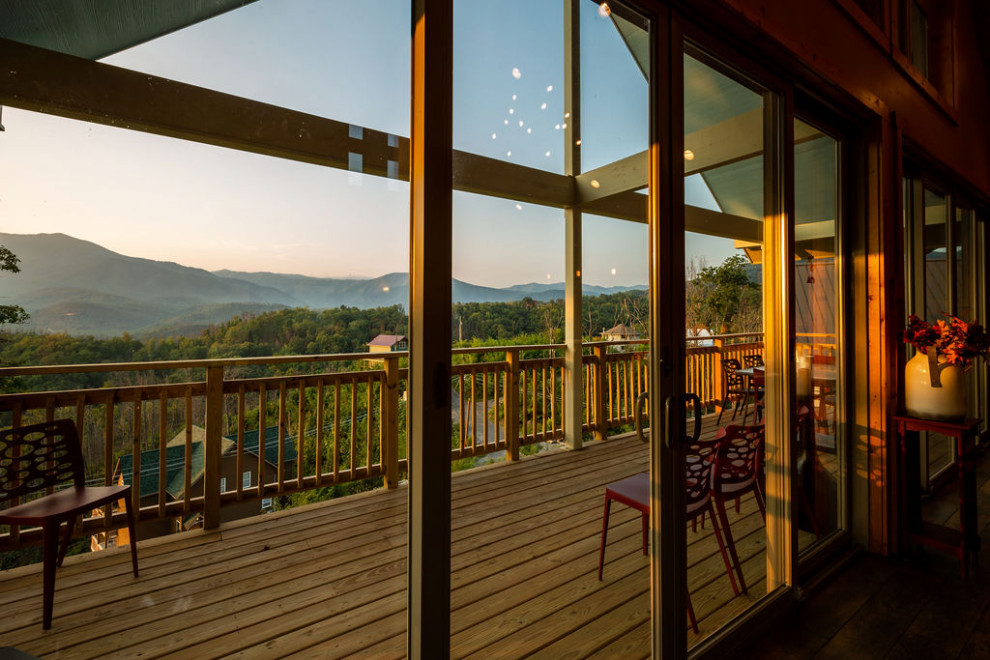 Deck - mid-sized rustic backyard deck idea with a roof extension