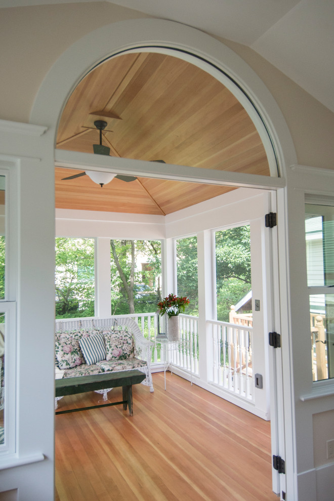 Mid-sized traditional sunroom in Detroit with light hardwood floors, a standard fireplace and a standard ceiling.