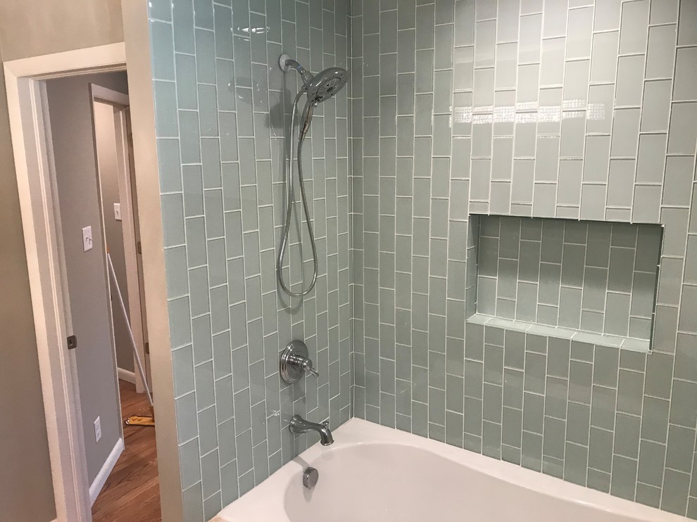 Design ideas for a mid-sized contemporary master bathroom in Denver with flat-panel cabinets, brown cabinets, an alcove tub, a shower/bathtub combo, a two-piece toilet, beige tile, glass tile, beige walls, porcelain floors, an undermount sink, soapstone benchtops, beige floor and a shower curtain.