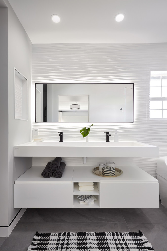 Inspiration for a large modern ensuite bathroom in San Francisco with flat-panel cabinets, white cabinets, an alcove shower, a wall mounted toilet, white tiles, porcelain tiles, grey walls, porcelain flooring, an integrated sink, engineered stone worktops, grey floors, a hinged door, white worktops, a wall niche, double sinks and a floating vanity unit.