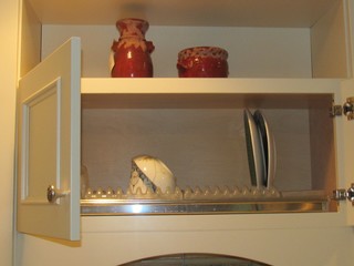 Custom, in-cabinet dish drying rack. Water drips directly into the sink. -  Transitional - Kitchen - Seattle - by Genay Bell Interior Design