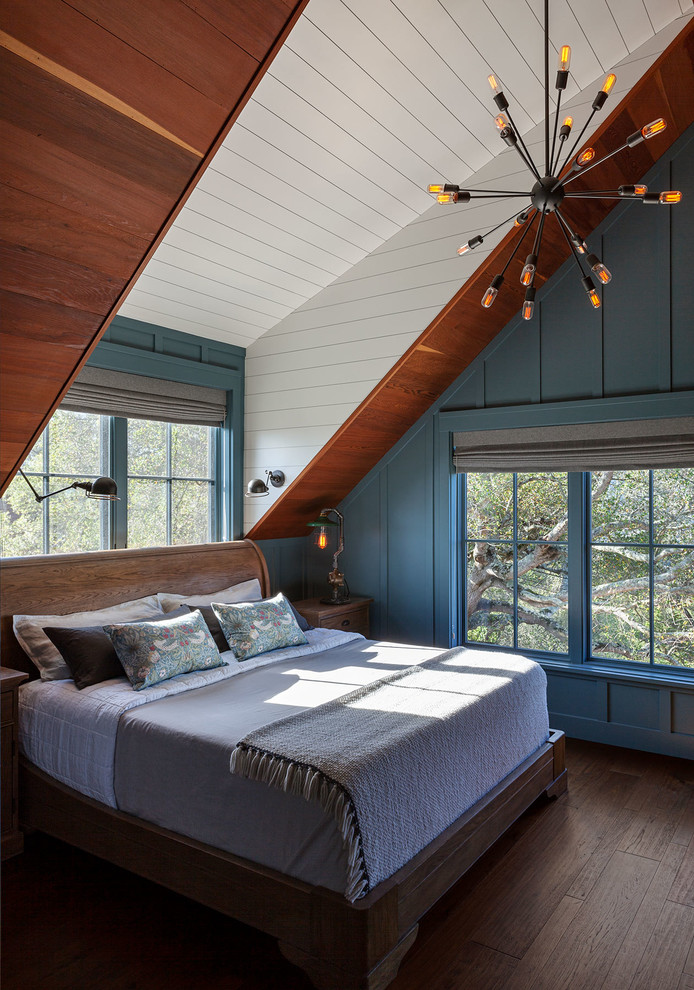 This is an example of a country bedroom in San Francisco with blue walls, medium hardwood floors and brown floor.