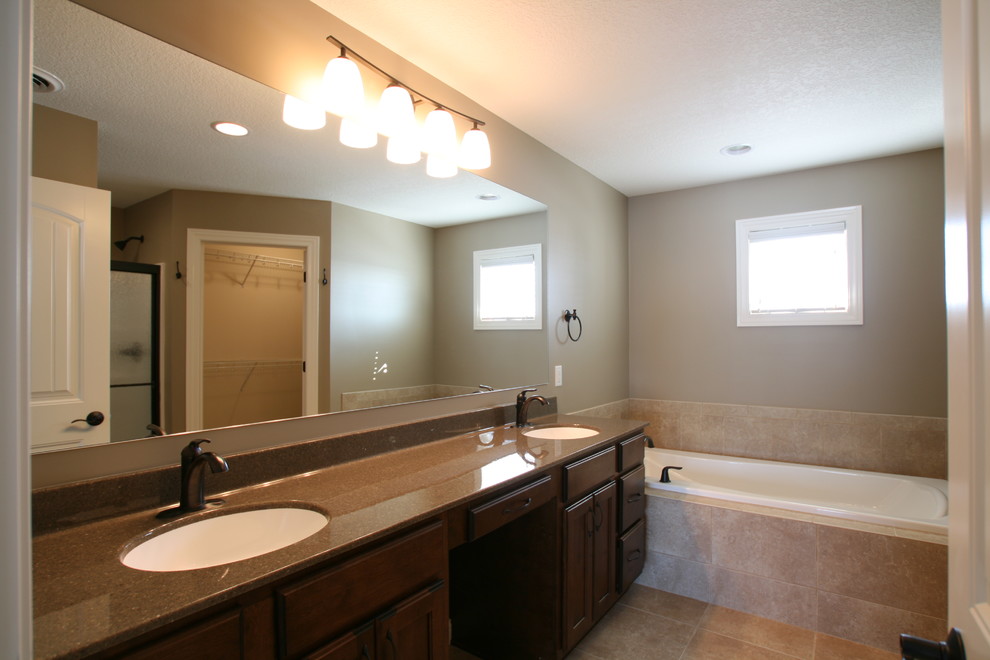 Transitional beige tile and ceramic tile drop-in bathtub photo in Chicago with an undermount sink, flat-panel cabinets and medium tone wood cabinets