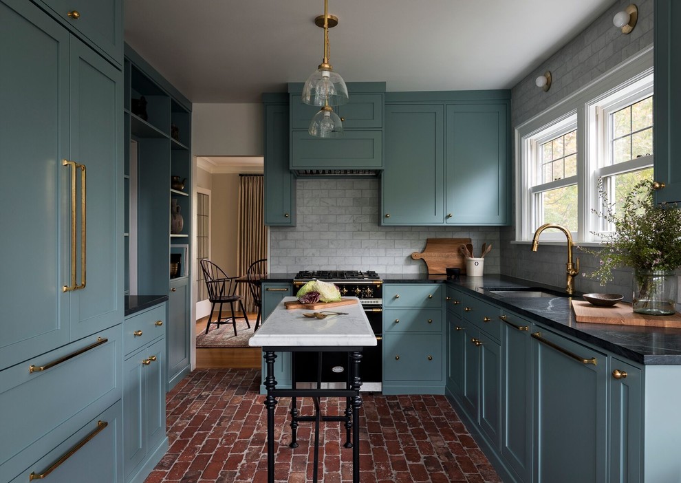 Inspiration for a traditional u-shaped kitchen in Seattle with an undermount sink, shaker cabinets, blue cabinets, white splashback, coloured appliances, brick floors, with island, red floor and brown benchtop.