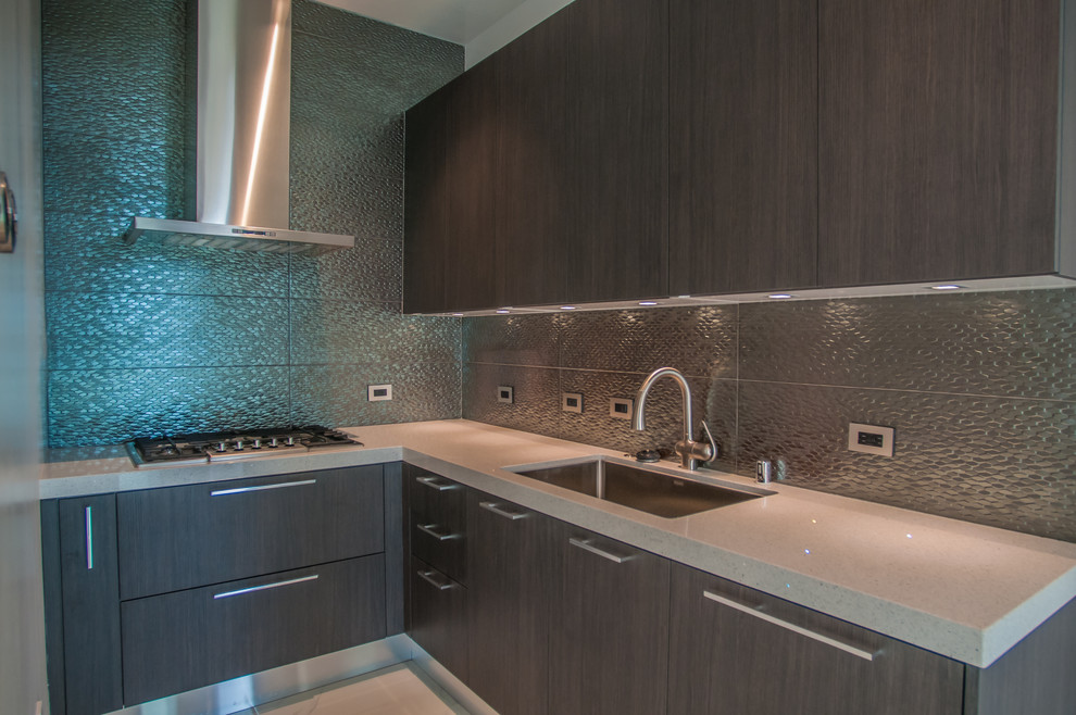 This is an example of a mid-sized contemporary l-shaped separate kitchen in Los Angeles with a single-bowl sink, flat-panel cabinets, dark wood cabinets, quartzite benchtops, metallic splashback, metal splashback and a peninsula.