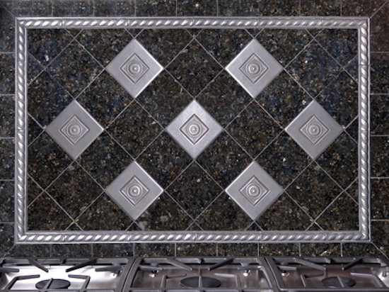 Example of a kitchen design in Boston with metallic backsplash and stainless steel appliances