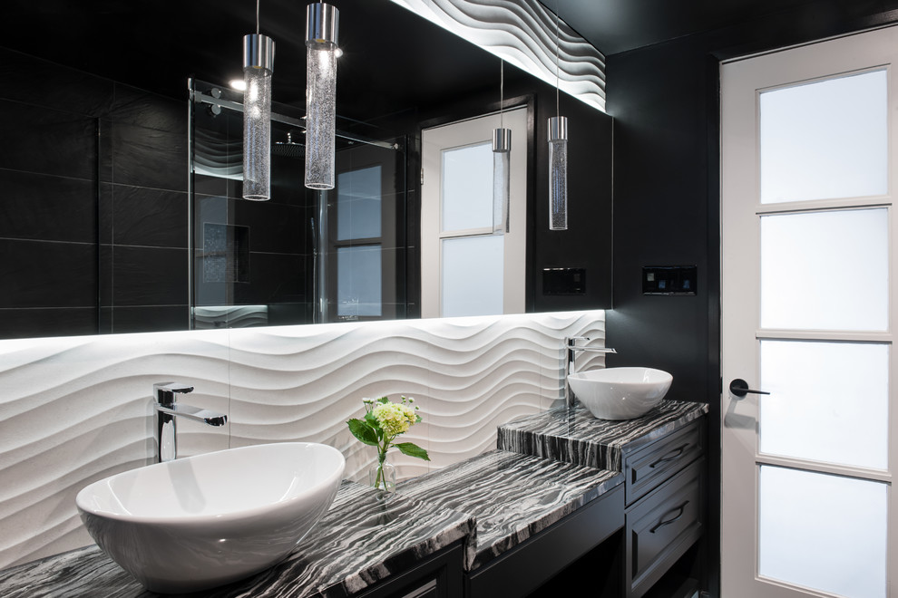 Photo of a small contemporary master bathroom in Other with raised-panel cabinets, black cabinets, a freestanding tub, a corner shower, a wall-mount toilet, black tile, ceramic tile, black walls, ceramic floors, a vessel sink and granite benchtops.