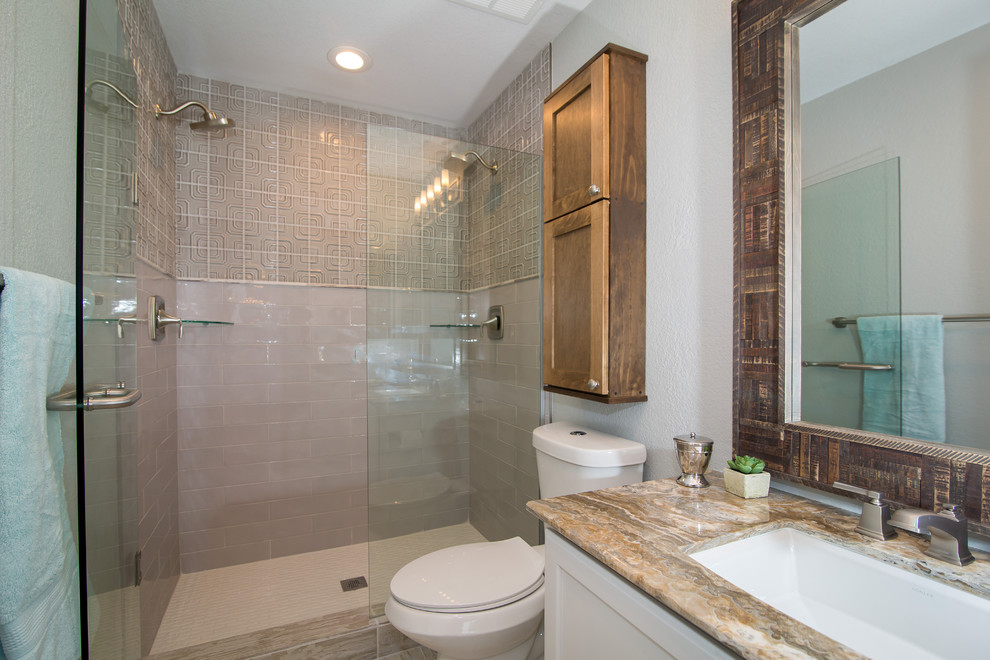 Inspiration for a mid-sized country 3/4 bathroom in Denver with recessed-panel cabinets, white cabinets, an alcove shower, a two-piece toilet, beige tile, cement tile, white walls, porcelain floors, an undermount sink, engineered quartz benchtops, beige floor and a hinged shower door.