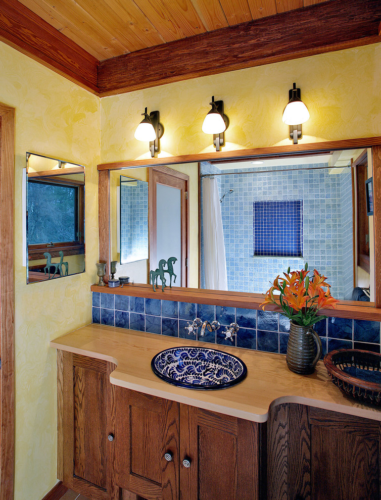 Photo of a mediterranean bathroom in DC Metro with a drop-in sink, wood benchtops, yellow walls and beige benchtops.