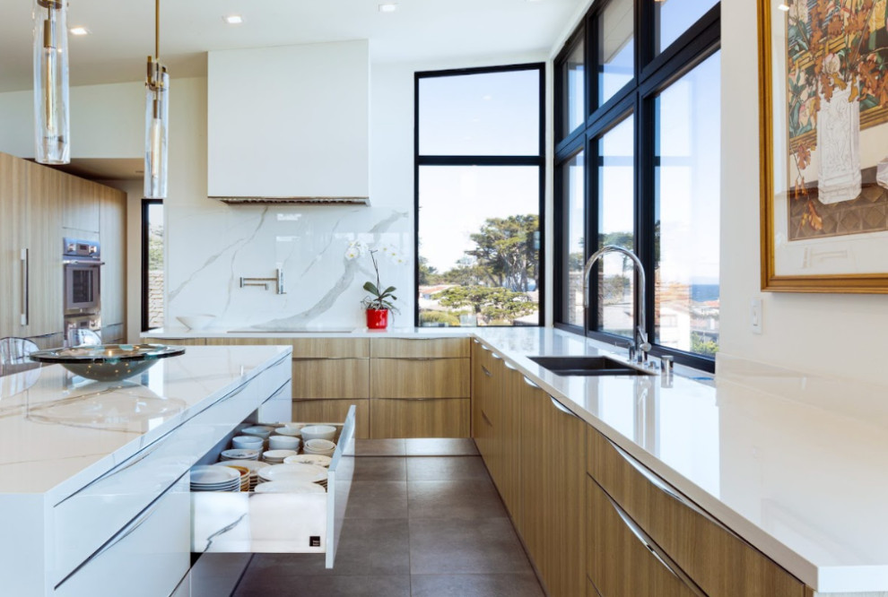This is an example of a large modern u-shaped kitchen/diner in Los Angeles with a submerged sink, flat-panel cabinets, light wood cabinets, marble worktops, white splashback, mosaic tiled splashback, integrated appliances, ceramic flooring, an island, grey floors and white worktops.