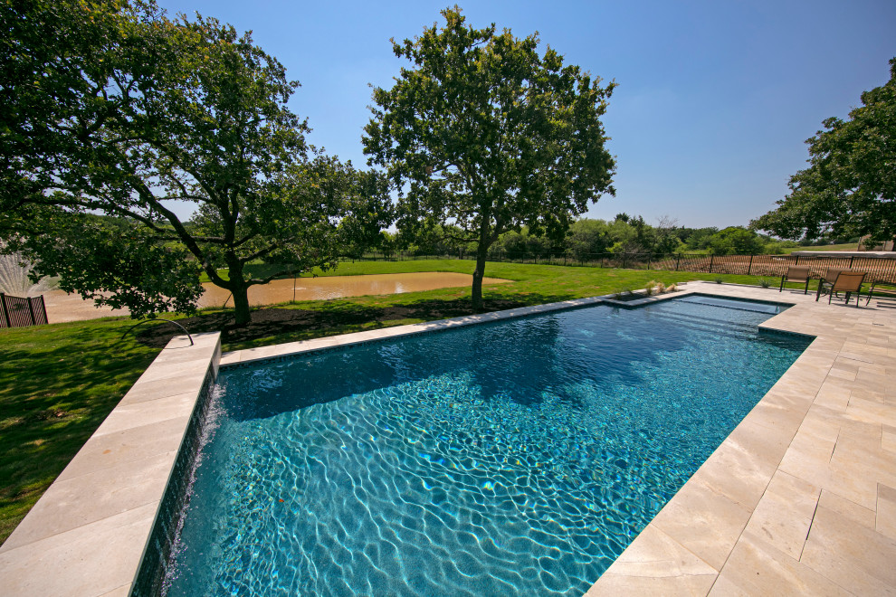 Example of a huge transitional two-story white pool design in Dallas