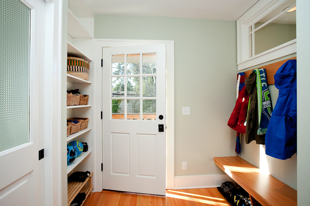 Design ideas for a mid-sized traditional mudroom in Seattle with green walls, medium hardwood floors, a single front door and a white front door.