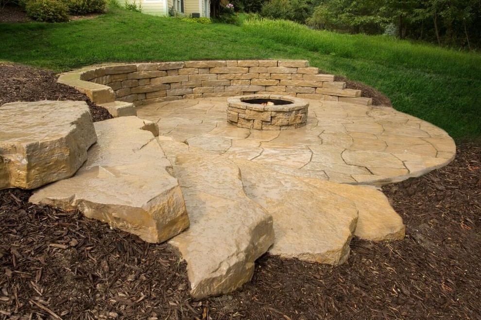 Design ideas for a mid-sized transitional full sun backyard stone landscaping in Chicago.
