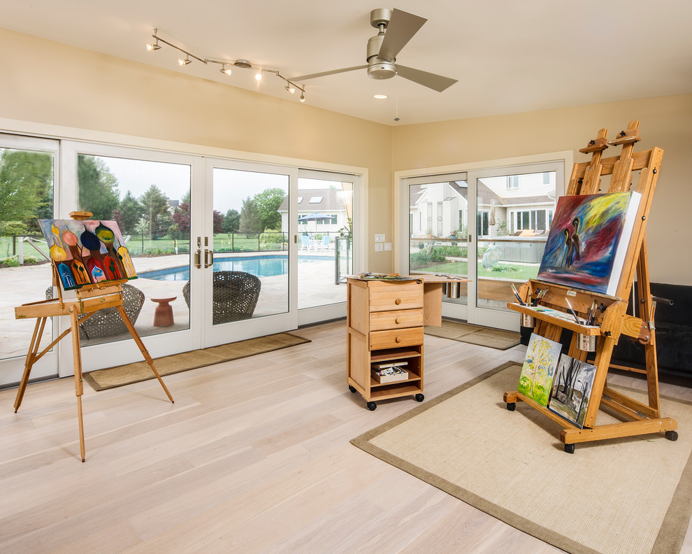 This is an example of a large traditional craft room in Philadelphia with beige walls and beige floor.