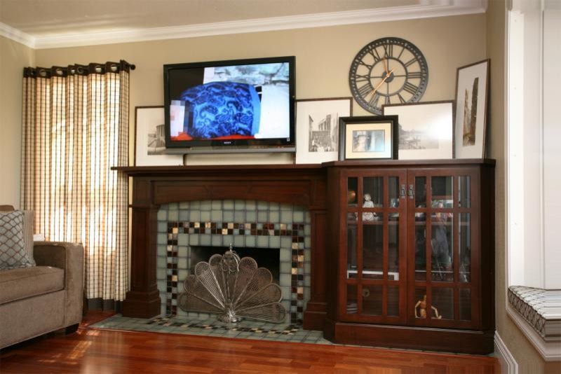 This is an example of a mid-sized traditional open concept family room in Orange County with beige walls, medium hardwood floors, a standard fireplace, a tile fireplace surround and a wall-mounted tv.