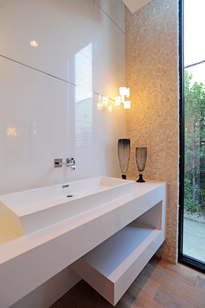 This is an example of a contemporary powder room in Los Angeles with a vessel sink and white tile.