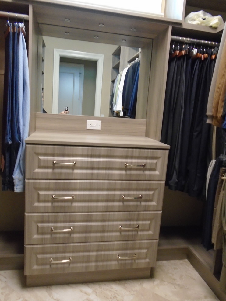 Photo of a large traditional gender-neutral walk-in wardrobe in Miami with raised-panel cabinets, grey cabinets, marble floors and beige floor.