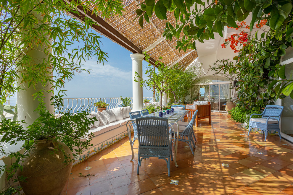 This is an example of a mediterranean first floor deck in Naples with metal railing.