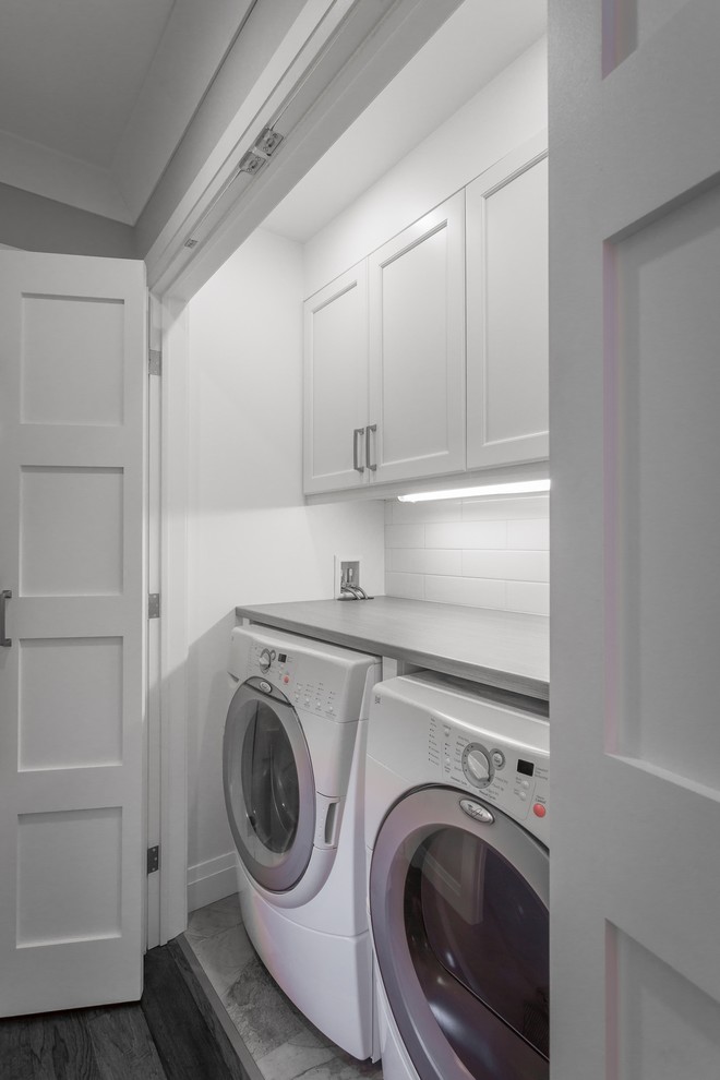 Design ideas for a small transitional single-wall laundry cupboard in Ottawa with shaker cabinets, white cabinets, laminate benchtops, white walls, porcelain floors and a side-by-side washer and dryer.