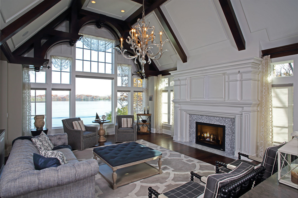Large traditional open concept living room in Minneapolis with dark hardwood floors, a standard fireplace, a tile fireplace surround, brown floor, white walls and a concealed tv.
