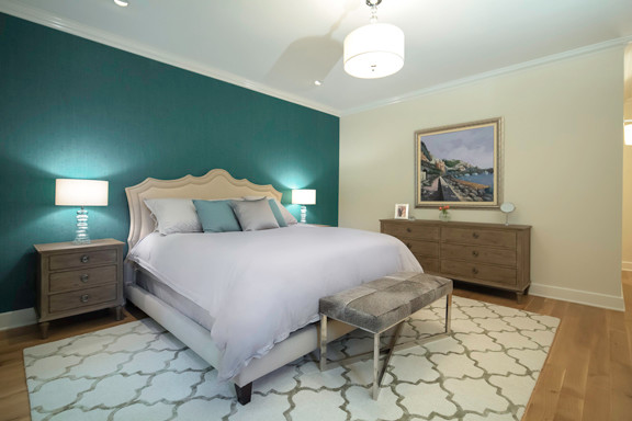 Design ideas for a transitional master bedroom in New York with beige walls.