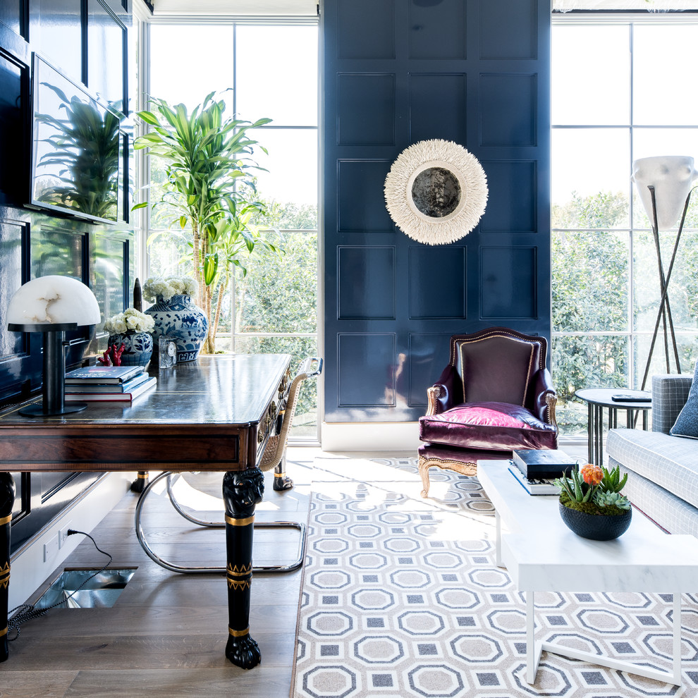 This is an example of a mid-sized eclectic home office in Dallas with blue walls, medium hardwood floors, brown floor and no fireplace.