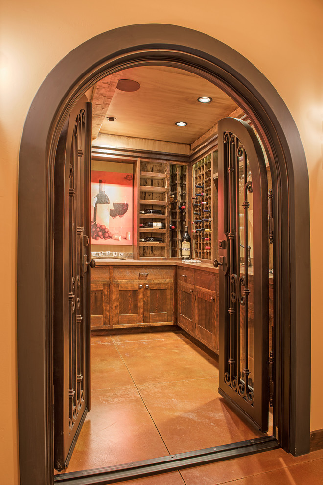 This is an example of a country wine cellar in Other with laminate floors, display racks and multi-coloured floor.