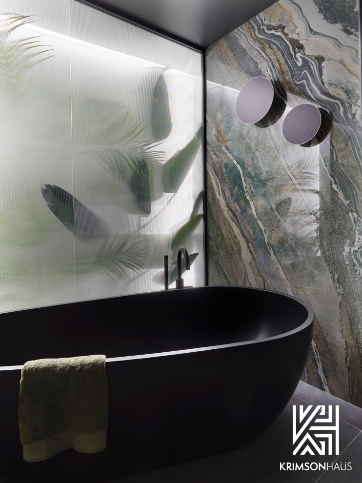 Photo of a large contemporary ensuite wet room bathroom in Los Angeles with a freestanding bath, black tiles, stone slabs, green walls, porcelain flooring and grey floors.