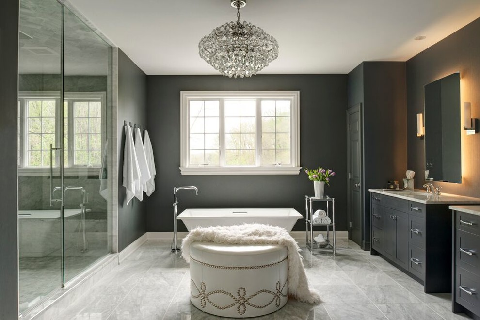 Transitional master bathroom in Philadelphia with shaker cabinets, black cabinets, a freestanding tub, an alcove shower, black walls, marble floors, gray tile, stone slab and marble benchtops.