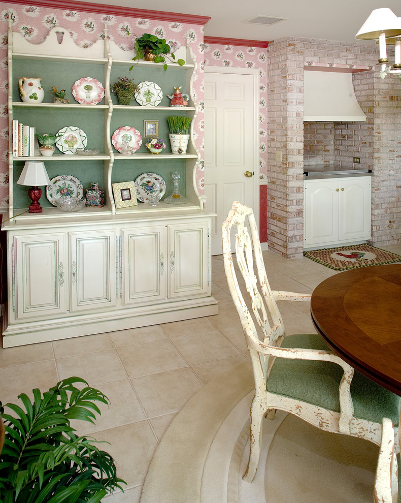 Photo of a mid-sized traditional separate dining room with pink walls, travertine floors, no fireplace and beige floor.