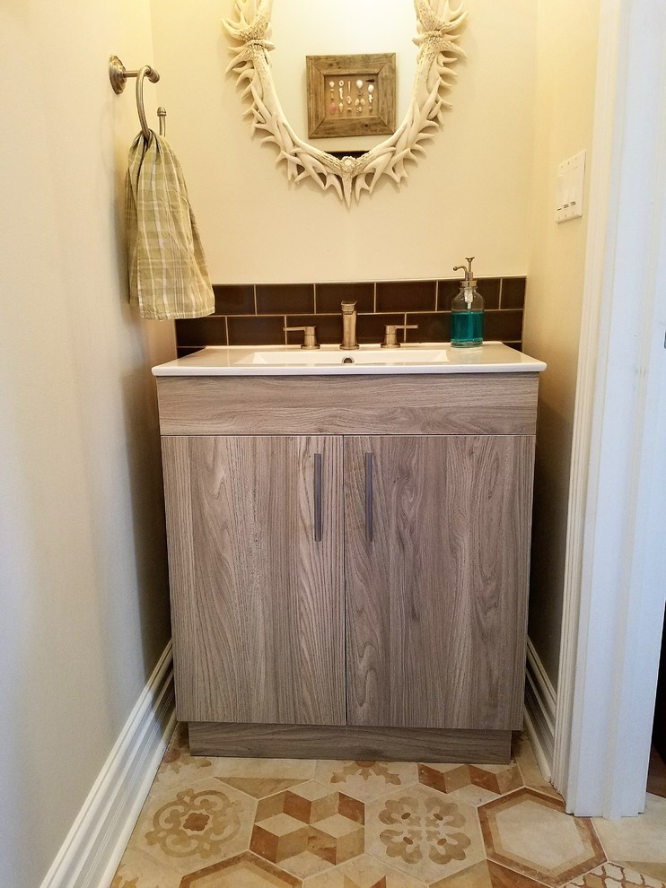 Design ideas for a small eclectic powder room in Chicago with flat-panel cabinets, light wood cabinets, black tile, ceramic tile, beige walls, porcelain floors, an integrated sink, solid surface benchtops and beige floor.