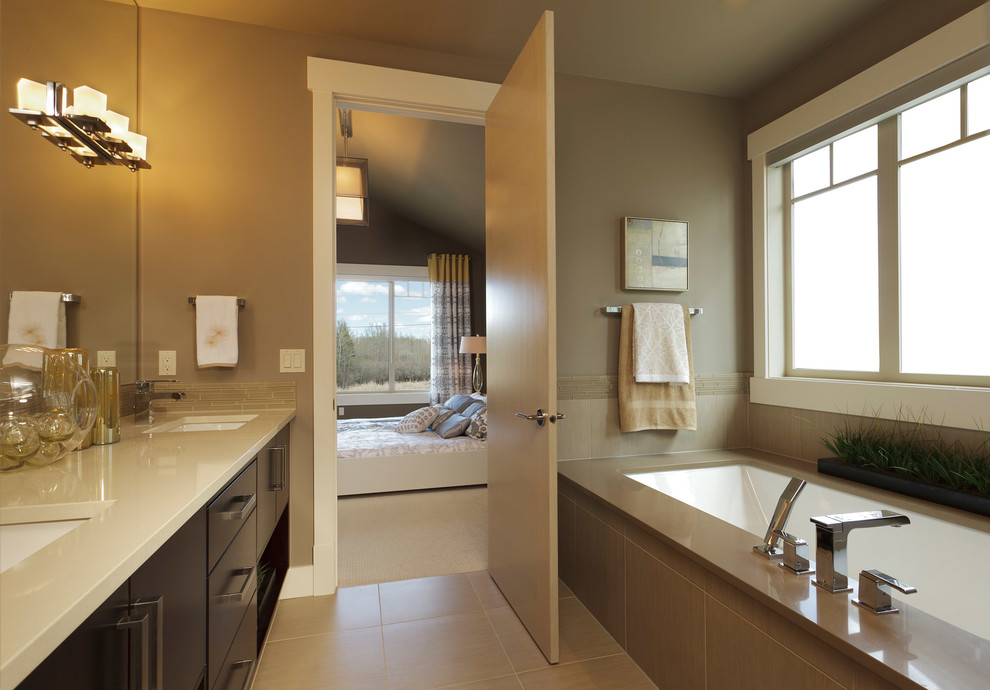 Inspiration for a contemporary master bathroom in Calgary with flat-panel cabinets, dark wood cabinets, an undermount tub, brown tile, brown walls, ceramic floors, an undermount sink and quartzite benchtops.