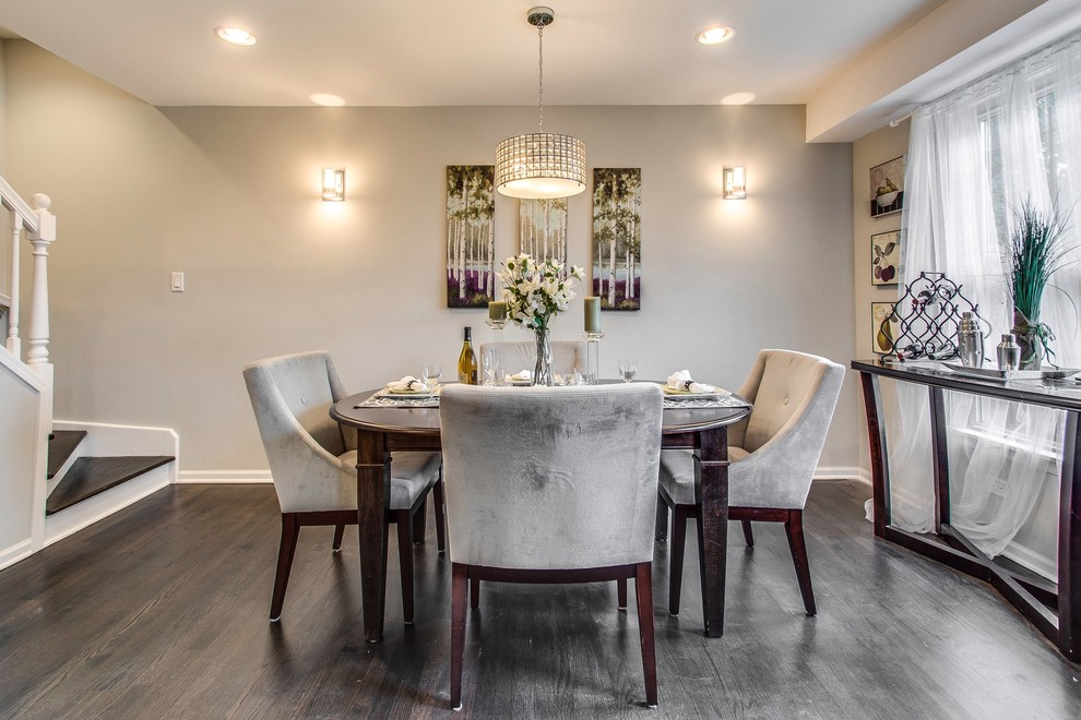 Photo of a transitional dining room in Chicago with grey walls.