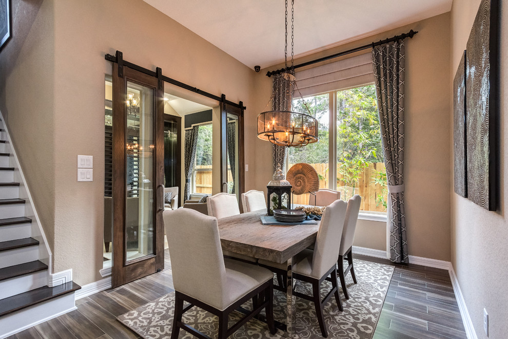 This is an example of a transitional dining room in Houston.