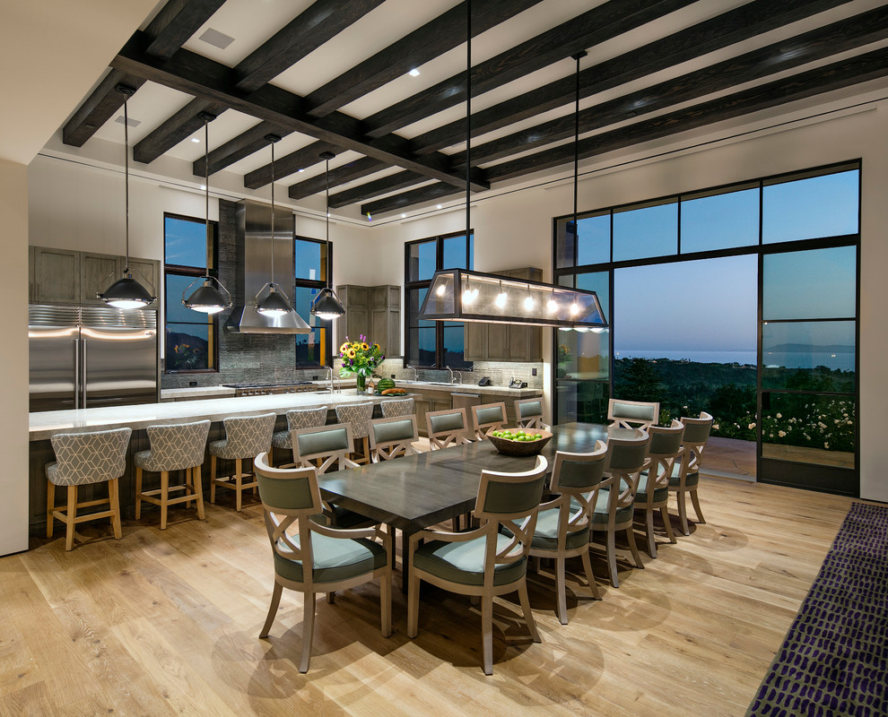 Photo of an expansive contemporary open plan dining in Santa Barbara with white walls and medium hardwood floors.